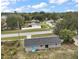 Aerial view of a home showing the backyard and roof with sliding glass doors and trees at 425 Marion Oaks Dr, Ocala, FL 34473