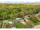 Aerial view of home in a lush neighborhood featuring solar panels and mature trees at 4251 Magnolia Ave, Leesburg, FL 34748