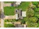 Aerial view of property showcasing the roof, solar panels, driveway and surrounding landscaping at 4251 Magnolia Ave, Leesburg, FL 34748