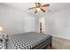 A cozy bedroom offers neutral colors, a ceiling fan, and a spacious closet at 4251 Magnolia Ave, Leesburg, FL 34748