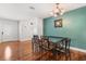 Dining room features hard wood floors, modern light fixture and accent wall at 4251 Magnolia Ave, Leesburg, FL 34748