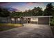 Charming single story home boasts a large covered carport, pergola, and easy to maintain landscaping at 4251 Magnolia Ave, Leesburg, FL 34748