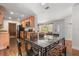 Open-concept kitchen and dining area with wooden floors, stainless steel appliances and granite countertops at 4251 Magnolia Ave, Leesburg, FL 34748