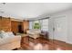 Cozy living room with barn door, white sofas, wood flooring, and lots of natural light at 4251 Magnolia Ave, Leesburg, FL 34748