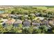 A high angle shot showing the property amongst similar homes with screened in pools in a suburban community at 4328 Acorn Ct, Davenport, FL 33837