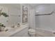 This bathroom offers a shower-tub combination with a vanity, mirror, and tiled accents at 4328 Acorn Ct, Davenport, FL 33837