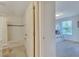 Bathroom leading to a bedroom with bunkbeds, featuring a bath tub, toilet, and tiled floor at 4328 Acorn Ct, Davenport, FL 33837