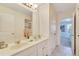 Bathroom with double sinks, white countertops, a large mirror, and tile flooring at 4328 Acorn Ct, Davenport, FL 33837