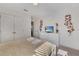 Light-filled bedroom with a queen bed, dresser, and closet at 4328 Acorn Ct, Davenport, FL 33837