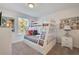 Cheerful bedroom with a bunk bed, vibrant bedding, and artwork on the walls at 4328 Acorn Ct, Davenport, FL 33837