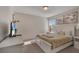 This bedroom is furnished with a queen bed, carpet flooring, and a TV at 4328 Acorn Ct, Davenport, FL 33837