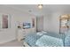 Cozy bedroom with a patterned queen bed, TV, dresser, and ensuite bathroom at 4328 Acorn Ct, Davenport, FL 33837