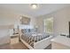 Comfortable bedroom with a queen-sized bed, bedside tables, lamps, and a window at 4328 Acorn Ct, Davenport, FL 33837
