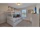 Bright bedroom featuring a bunk bed with colorful bedding, carpet flooring, and decor at 4328 Acorn Ct, Davenport, FL 33837
