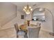 The dining area showcases a round table with decorative chairs and a stylish chandelier lighting the space at 4328 Acorn Ct, Davenport, FL 33837