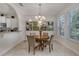 Charming dining area features a round table, golf-themed artwork, and natural light from a large window at 4328 Acorn Ct, Davenport, FL 33837