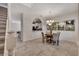 Elegant dining area showcasing tile floors, decorative lighting, and adjacent kitchen with breakfast bar at 4328 Acorn Ct, Davenport, FL 33837