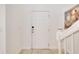 Bright and welcoming foyer with clean white walls and trim, tile flooring, and staircase at 4328 Acorn Ct, Davenport, FL 33837