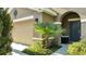 Welcoming front entrance with a neatly kept lawn, updated lighting, and attached two car garage at 4328 Acorn Ct, Davenport, FL 33837