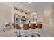 Kitchen with an island featuring a curved countertop and bar seating, with white cabinets and stainless appliances at 4328 Acorn Ct, Davenport, FL 33837