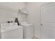 Well-equipped laundry room with modern washer, dryer, and ample shelving for storage at 4328 Acorn Ct, Davenport, FL 33837