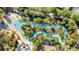 The community lazy river winds throughout lush landscaping at 4328 Acorn Ct, Davenport, FL 33837