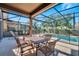 Outdoor dining has seating and is screened-in overlooking the refreshing pool at 4328 Acorn Ct, Davenport, FL 33837