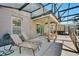 Relaxing outdoor patio boasts lounge seating, dining, and screened enclosure at 4328 Acorn Ct, Davenport, FL 33837