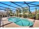 A beautiful screened-in swimming pool with crystal clear water and a spa offers a relaxing retreat at 4328 Acorn Ct, Davenport, FL 33837