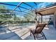 Outdoor patio has seating, a dining table, and a great view of the refreshing pool at 4328 Acorn Ct, Davenport, FL 33837