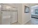 Modern tiled shower with glass doors and a tiled accent stripe, located adjacent to bedroom at 4328 Acorn Ct, Davenport, FL 33837