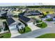Aerial view of homes featuring well-maintained lawns, mature trees, and a network of sidewalks at 463 Kayla Ct, The Villages, FL 32163