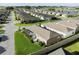 An aerial view showcases the charming single-Gathering homes in the community, nestled near the serene lake at 463 Kayla Ct, The Villages, FL 32163