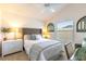 Cozy bedroom with a neutral color palette, a comfortable bed, and natural light from the window at 463 Kayla Ct, The Villages, FL 32163