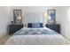 Stylishly decorated bedroom featuring a decorative headboard, matching bedside tables, and beautiful blue accents at 463 Kayla Ct, The Villages, FL 32163