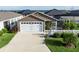 Charming home featuring a well-maintained yard, screened lanai, and a two-car garage, offering comfort and convenience at 463 Kayla Ct, The Villages, FL 32163