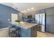Kitchen area featuring granite countertops, stainless steel appliances, and a breakfast bar at 463 Kayla Ct, The Villages, FL 32163