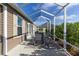 Spacious screened lanai featuring a dining set, offering a relaxing outdoor dining experience with serene views at 463 Kayla Ct, The Villages, FL 32163