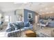 Bright living room featuring a comfortable blue-striped sofa and an adjacent dining area at 463 Kayla Ct, The Villages, FL 32163
