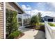 Charming screened-in porch with a concrete path surrounded by beautiful greenery, perfect for enjoying the outdoors bug-free at 463 Kayla Ct, The Villages, FL 32163