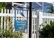 Close-up of Blue Heron Hideaway signage along a white picket fence at 463 Kayla Ct, The Villages, FL 32163