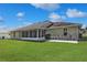 Wide shot of backyard, patio, and outdoor seating area at 4723 Saint Andrews Arc, Leesburg, FL 34748