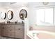 Bright bathroom features double sinks, granite counters, soaking tub, and ample lighting at 4723 Saint Andrews Arc, Leesburg, FL 34748