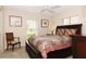 Comfortable bedroom featuring a ceiling fan and two large windows at 4723 Saint Andrews Arc, Leesburg, FL 34748