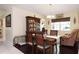 Cozy dining room with a wooden table, seating for four, and a view into the adjacent living spaces at 4723 Saint Andrews Arc, Leesburg, FL 34748