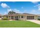 Charming single-story home featuring a well-manicured lawn and a screened-in garage, offering both curb appeal and functionality at 4723 Saint Andrews Arc, Leesburg, FL 34748