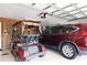 Spacious two car garage with golf cart and car parked inside at 4723 Saint Andrews Arc, Leesburg, FL 34748