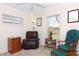 Living room with a recliner and lots of natural light from two windows at 4723 Saint Andrews Arc, Leesburg, FL 34748