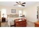 Cozy bedroom with a ceiling fan, neutral walls, and coordinated decor at 4723 Saint Andrews Arc, Leesburg, FL 34748