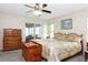 Main bedroom showcases sliding door access to the lanai and backyard at 4723 Saint Andrews Arc, Leesburg, FL 34748
